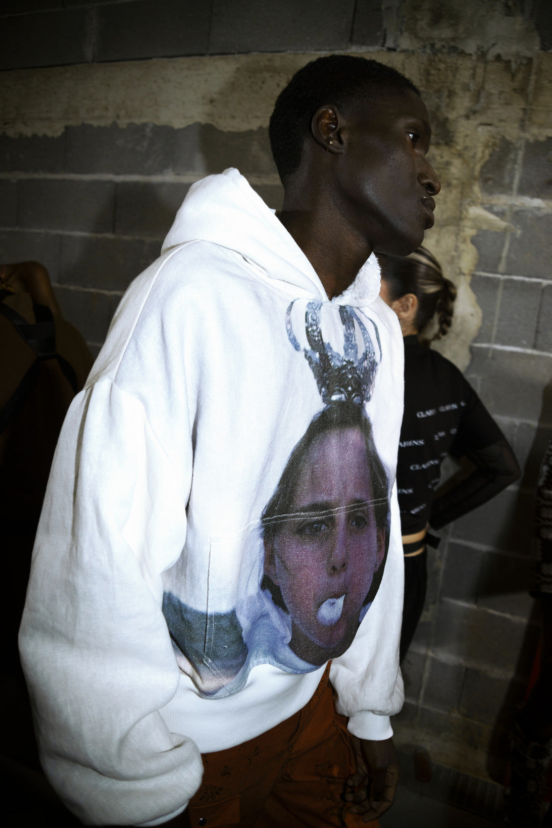 A person wearing a white hoodie with a photograph print on the front. Béhen - Gum Hoodie sold by two extra lives