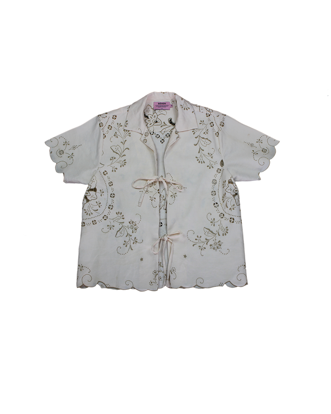 A white linen shirt with short sleeves and embroidered floral patterns on the front and back, displayed on a hanger. Béhen- Madeira Embroidery Shirt sold by two extra lives