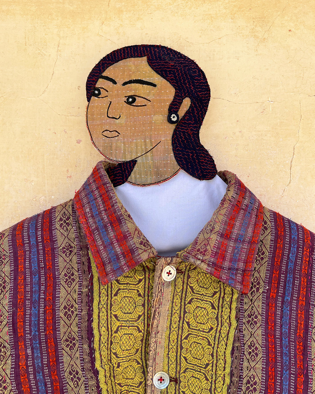 Mannequin wearing a traditional garment with a colorful pattern on a beige background DAY-AND-AGE-REX-JACKET-TWO-EXTRA-LIVES