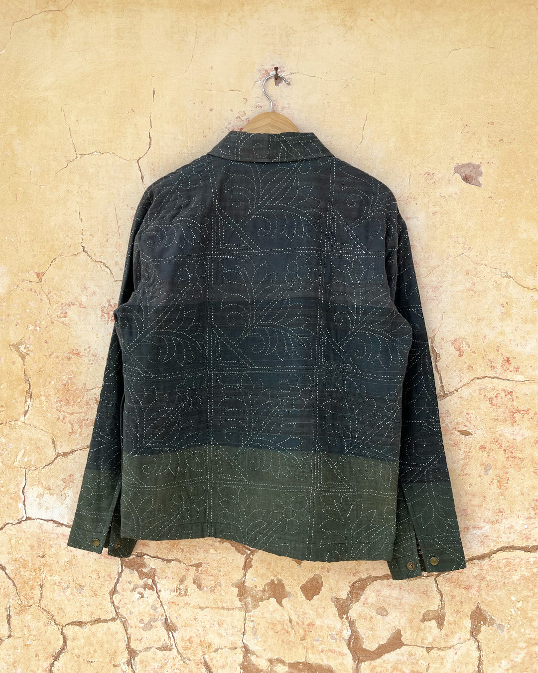 Dark green quilted jacket by Day and age on a mannequin by two extra lives