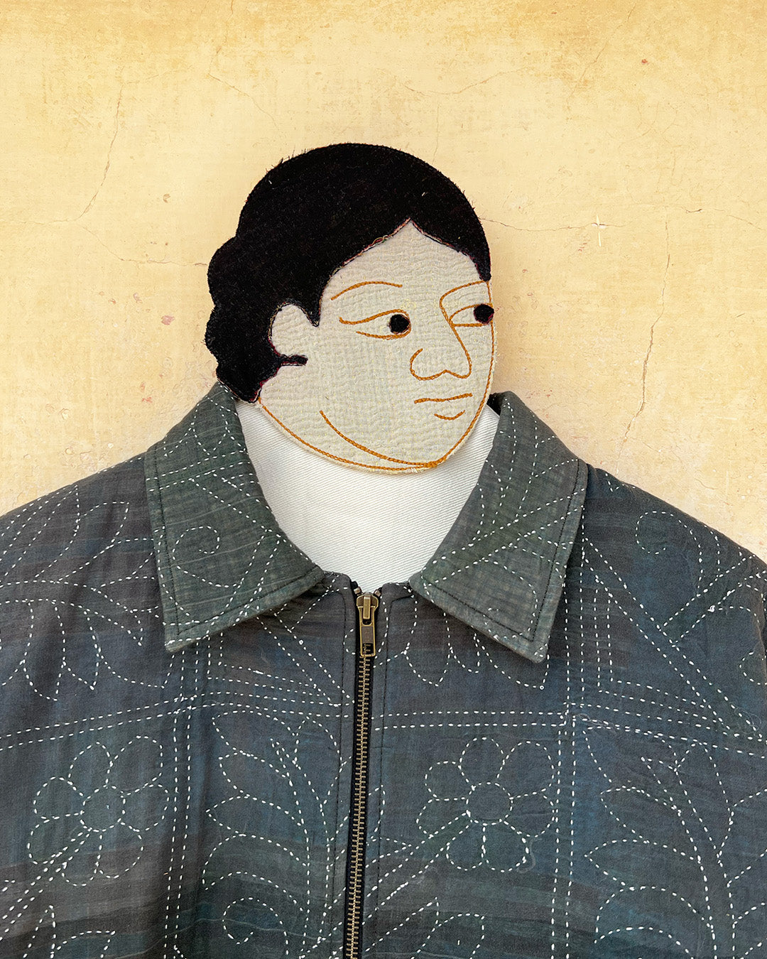 Dark green quilted jacket by Day and age on a mannequin by two extra lives