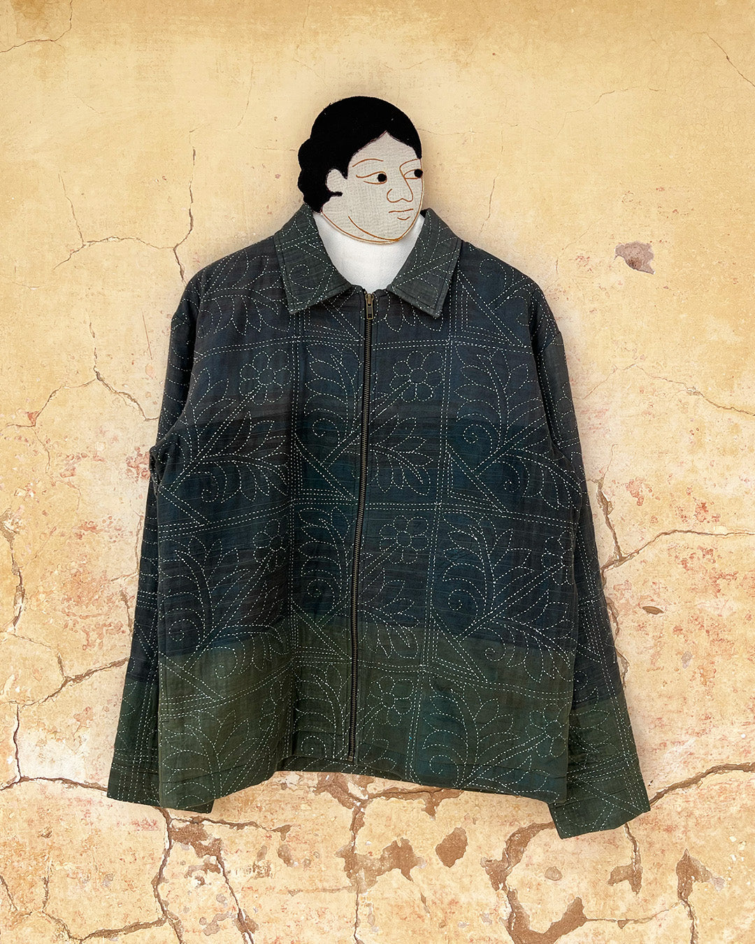 Dark green quilted jacket by Day and age on a mannequin by two extra lives