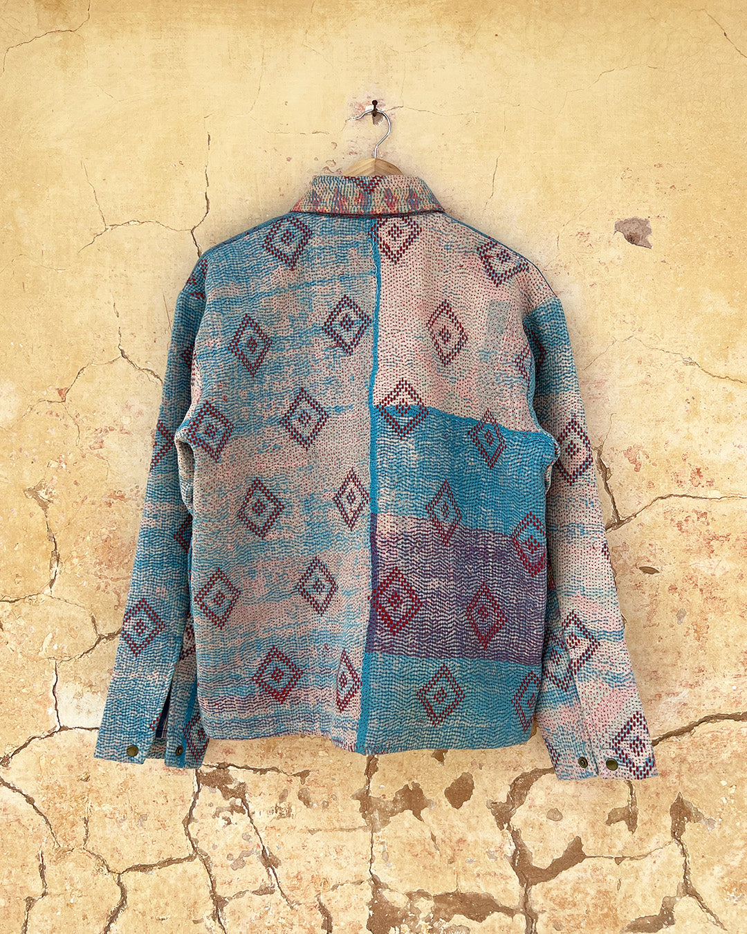 Blue patterned jacket by Day and Age on a textured beige background sold by two extra lives