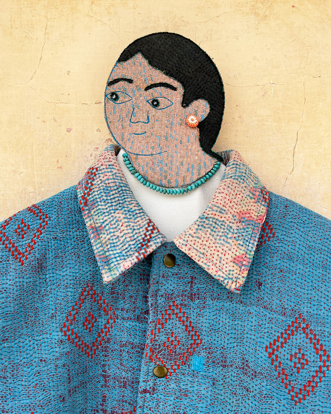 Blue patterned jacket by Day and Age on a textured beige background sold by two extra lives