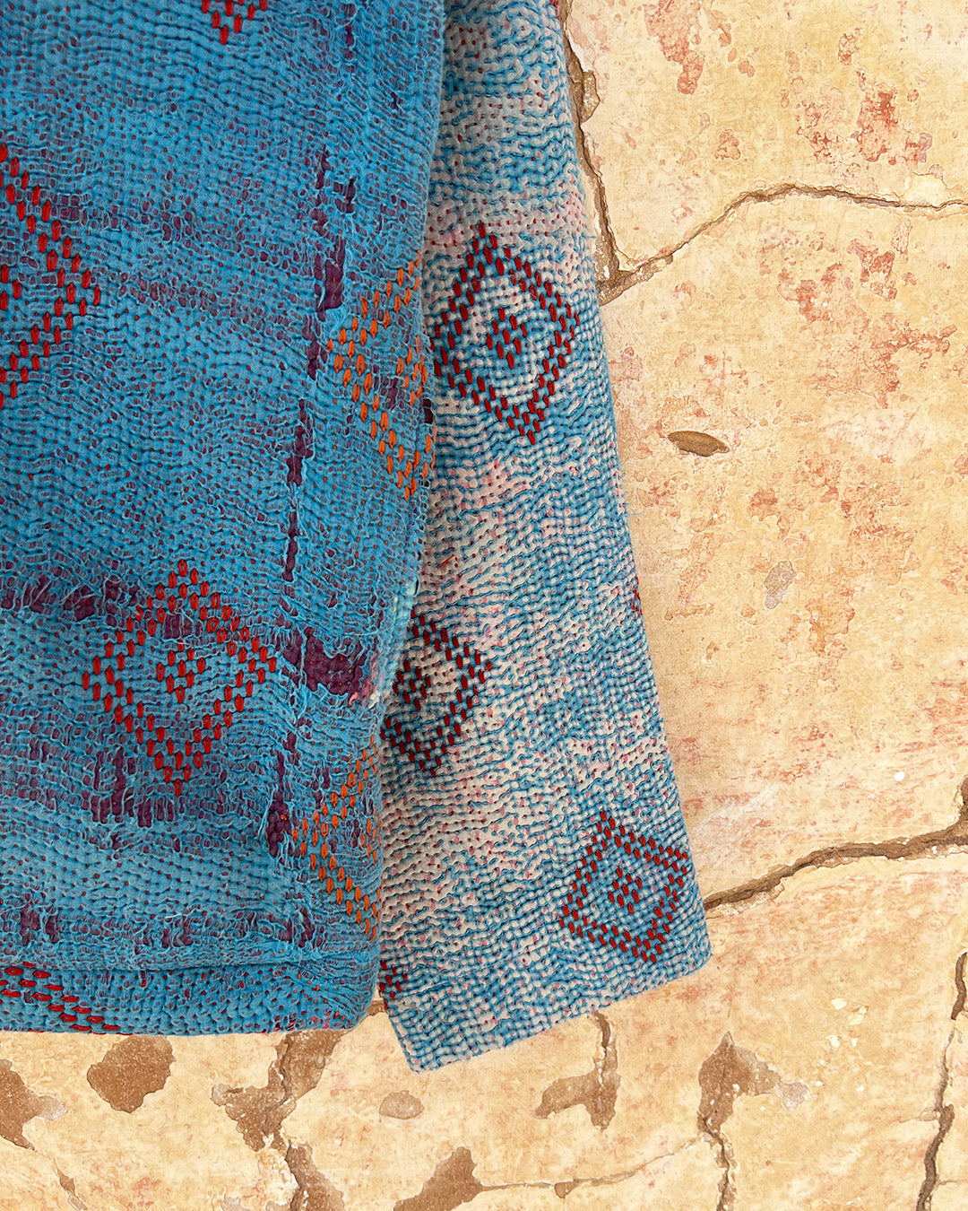Blue patterned jacket by Day and Age on a textured beige background sold by two extra lives