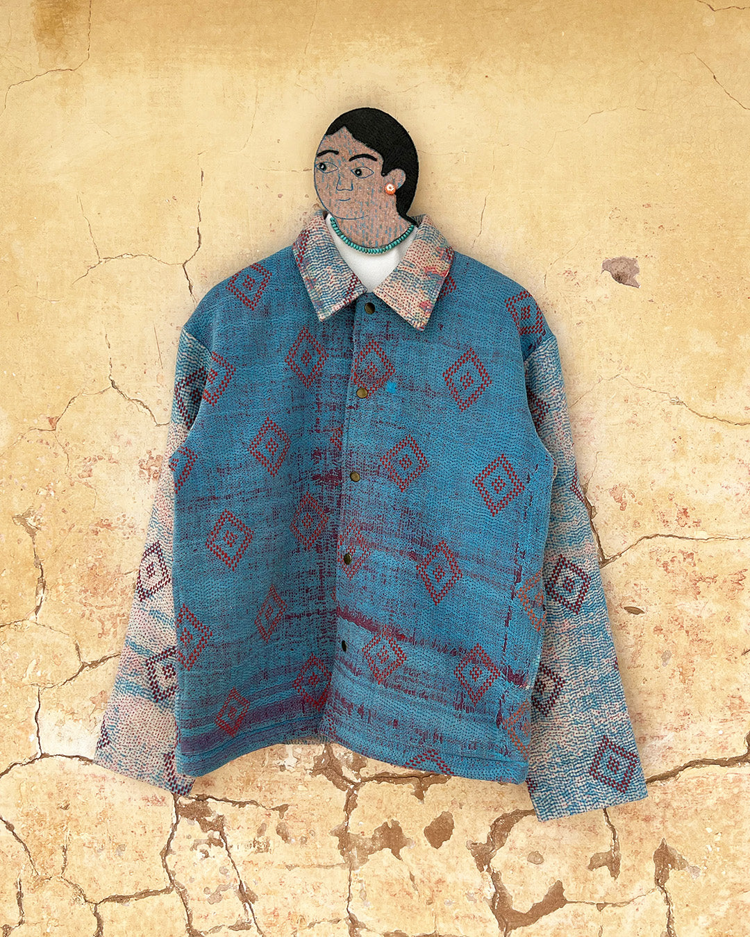 Blue patterned jacket by Day and Age on a textured beige background sold by two extra lives