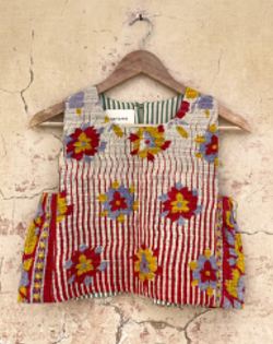 floral top by day and age on a hanger against a textured wall. by two extra lives
