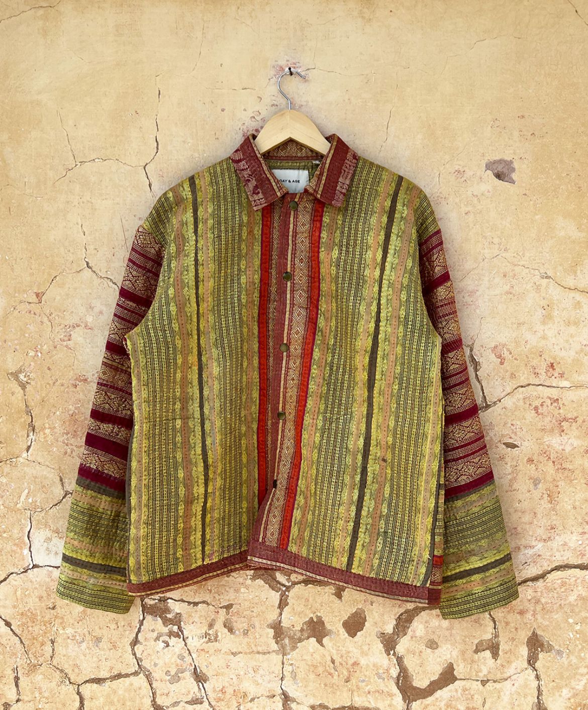 Textured shirt with striped pattern by day and age on a textured beige background by two extra lives