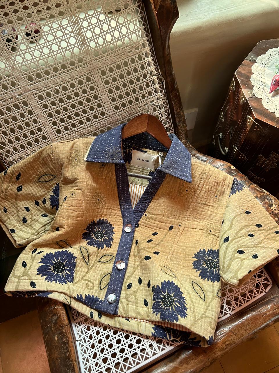 Day and Age quilt rajni shirt with blue floral patterns on a wooden surface by two extra lives