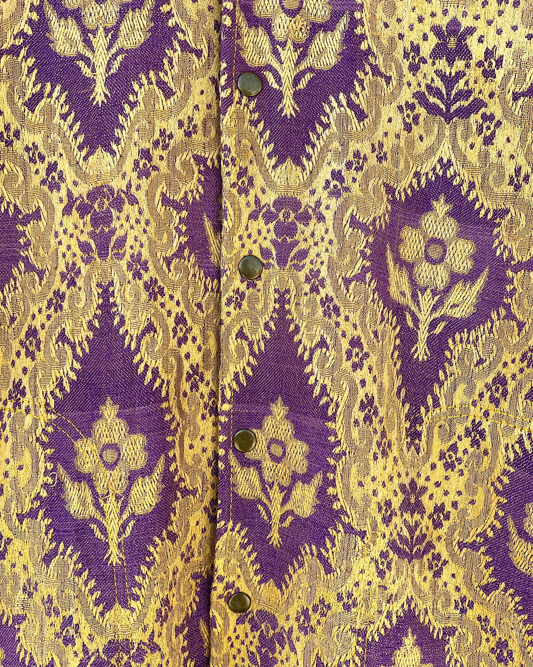Patterned shirt jacket by day and age on a hanger against a textured wall by two extra lives