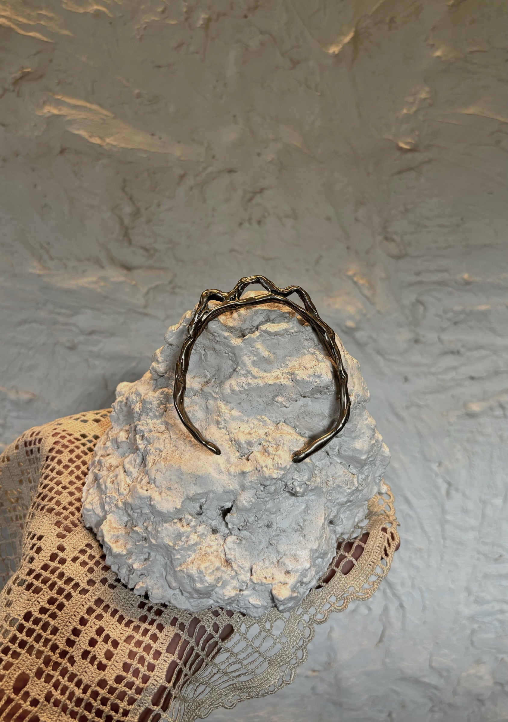 A person's wrist wearing a white rhodium-plated bronze bracelet with a sleek, modern design. 
Ex Nihilo - Mountain Bracelet sold by two extra lives