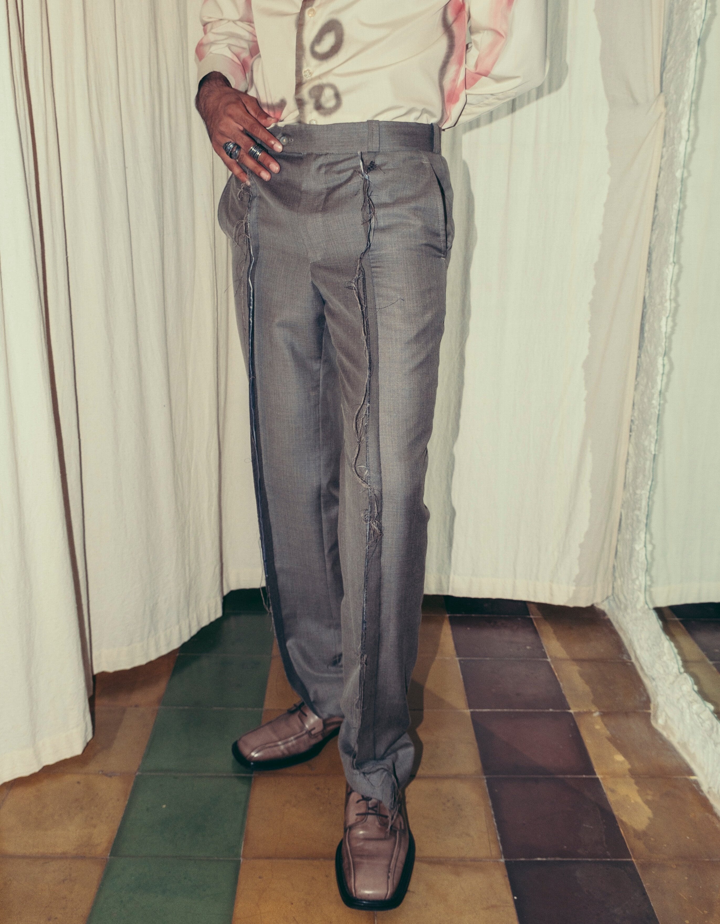 A person wearing grey inside-out pants Kuta House - Grey Inside-Out Pants two extra lives