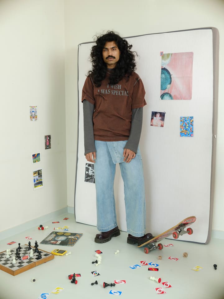 Person standing next to a large whiteboard with various items on a light-colored floor.