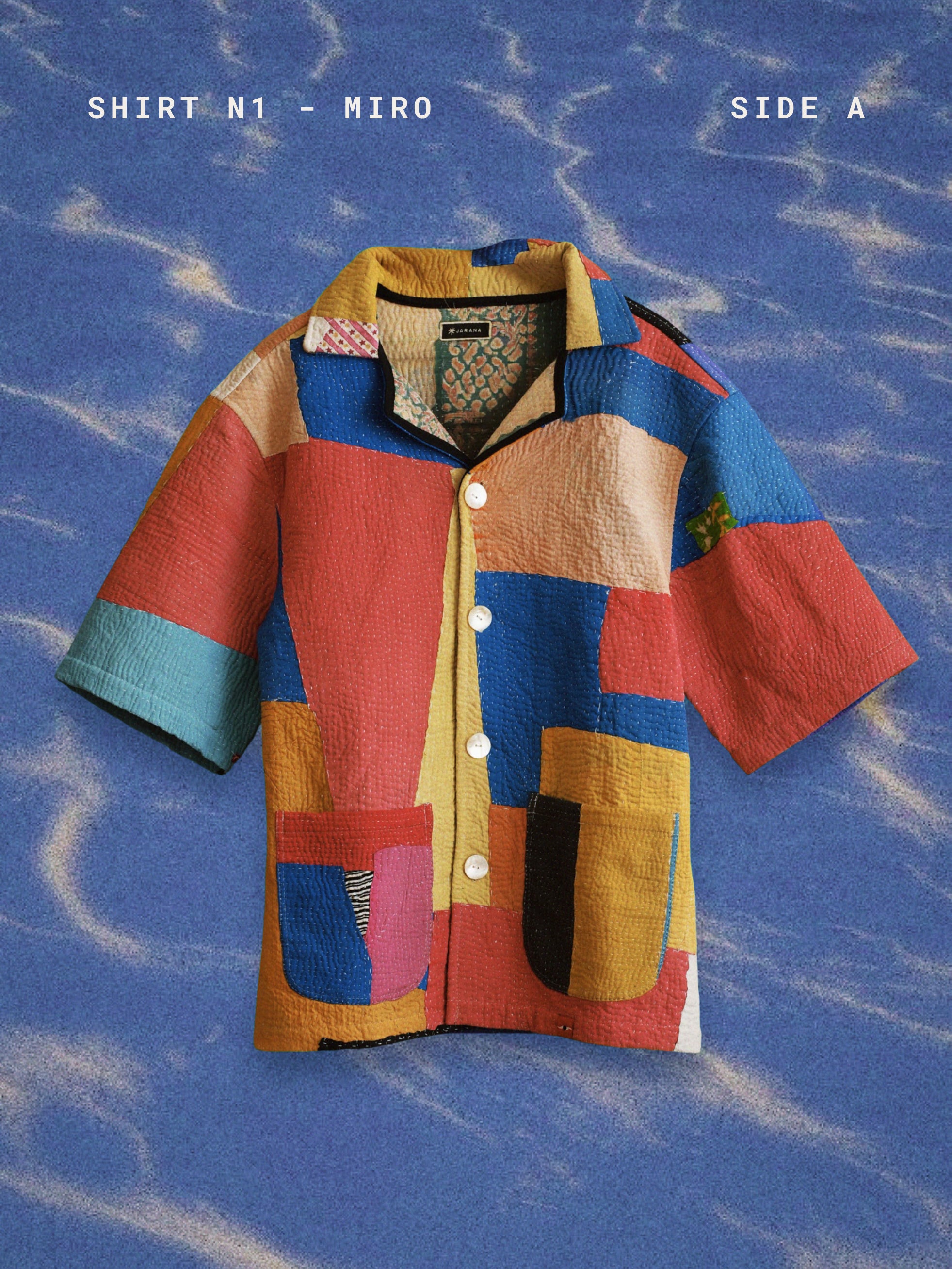 Colorful patchwork shirt on a blue textured background. TIRTHA-STUDIO-MIRO-SHIRT-TWO-EXTRA-LIVES